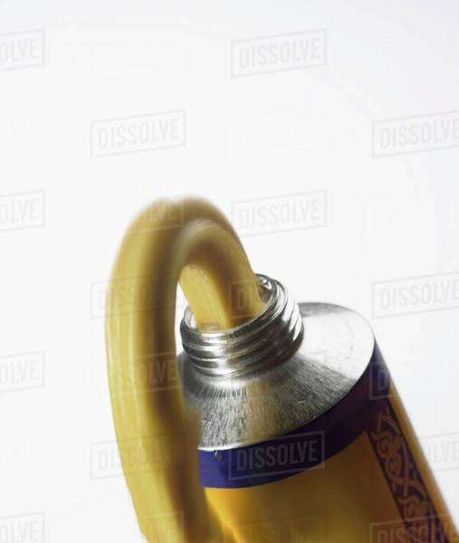 Mustard tube with squeezedout mustard Stock Photo Dissolve