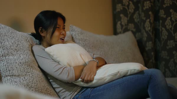 Pretty Asian Girl Hugs Pillow And Watches Tv Stock Video Footage