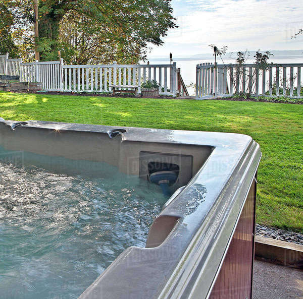 Close up of hot tub in backyard Stock Photo Dissolve