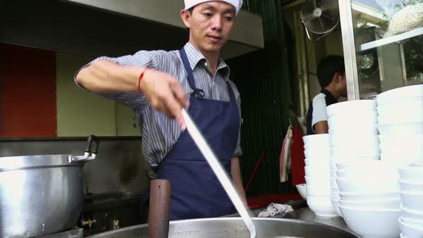 Chef Preparing Traditional Asian Street Food And Working In The