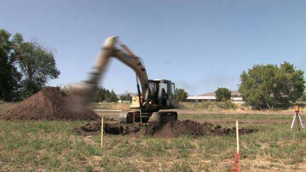 Backhoe Excavator Machine Digging A Basement For New House Or Backhoe Excavator Machine Digging A Basement For New House Or