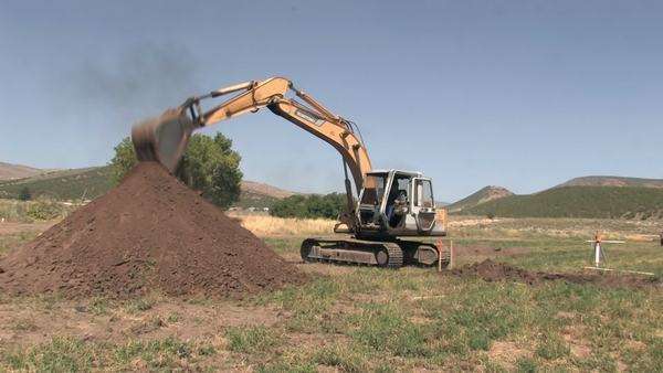 Large Backhoe Excavator Machine Digging A Basement For New House Large Backhoe Excavator Machine Digging A Basement For New House