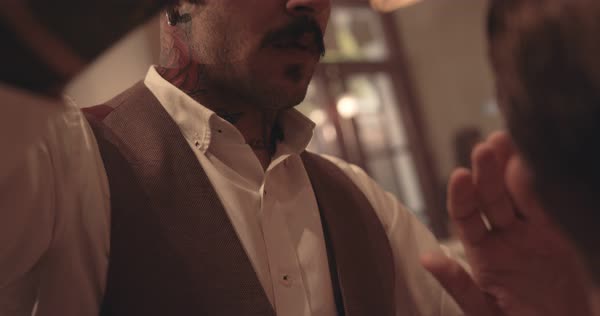 Hairstylist With Tattoos Styling Man S Hair In Old Fashioned