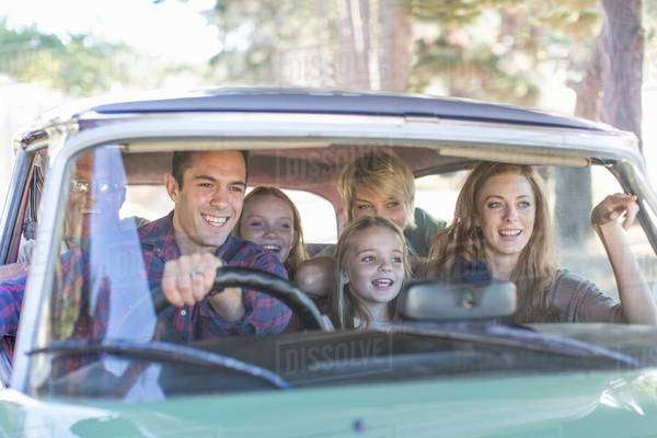 Family in car together, taking road trip - Stock Photo - Dissolve