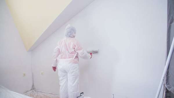 Painting New Room In Protective Suit Person Renovating Apartment