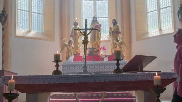 Two Older People Walking Up To The Church Altar Looking Up To The
