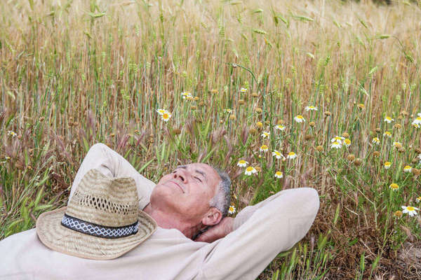 Man with hands behind head lying