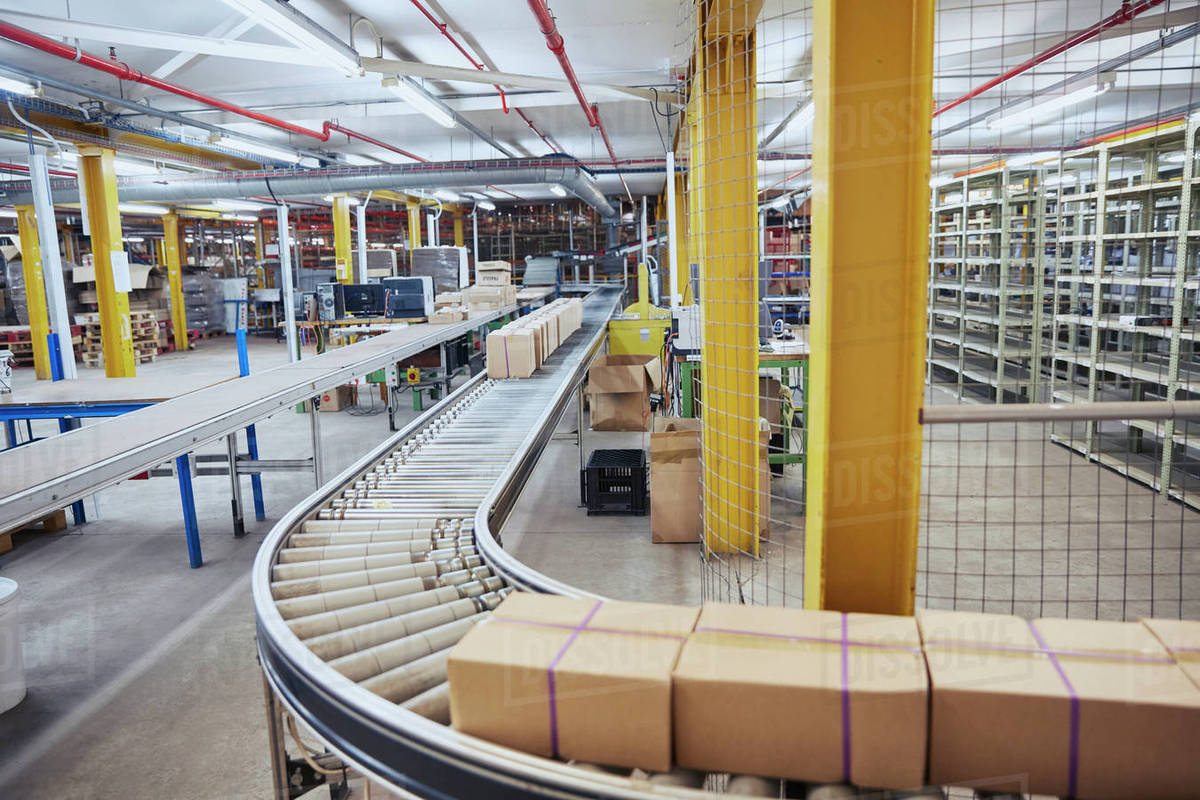 Cardboard Boxes On Conveyor Belt In Distribution Warehouse Stock Photo Dissolve