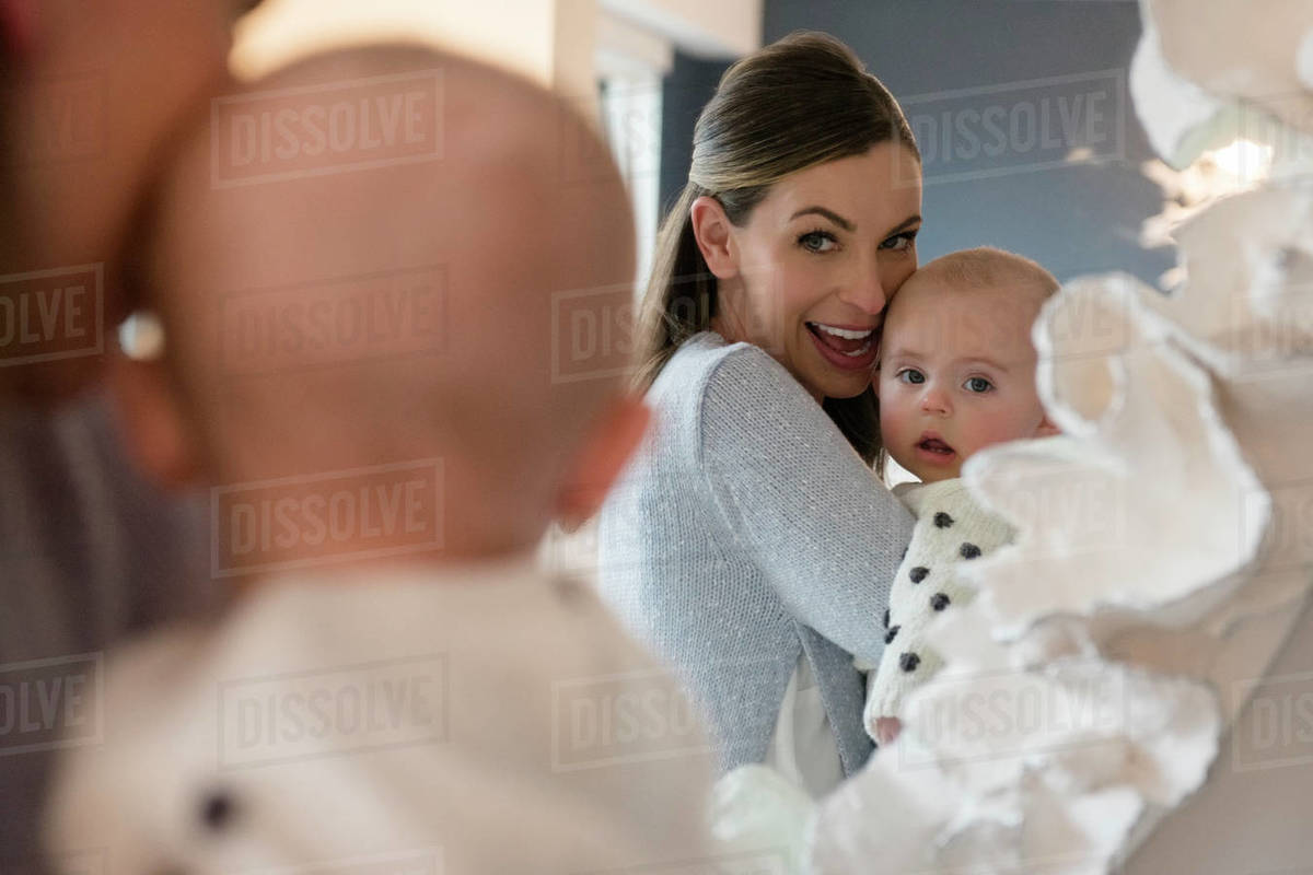 Mother holding baby (1823 months) in front of mirror Stock Photo