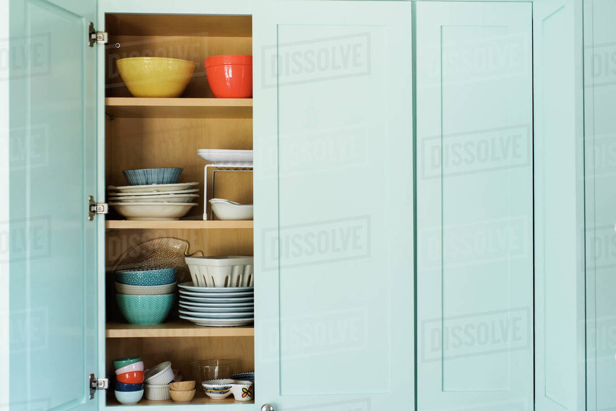 Dishes in cupboard Stock Photo Dissolve