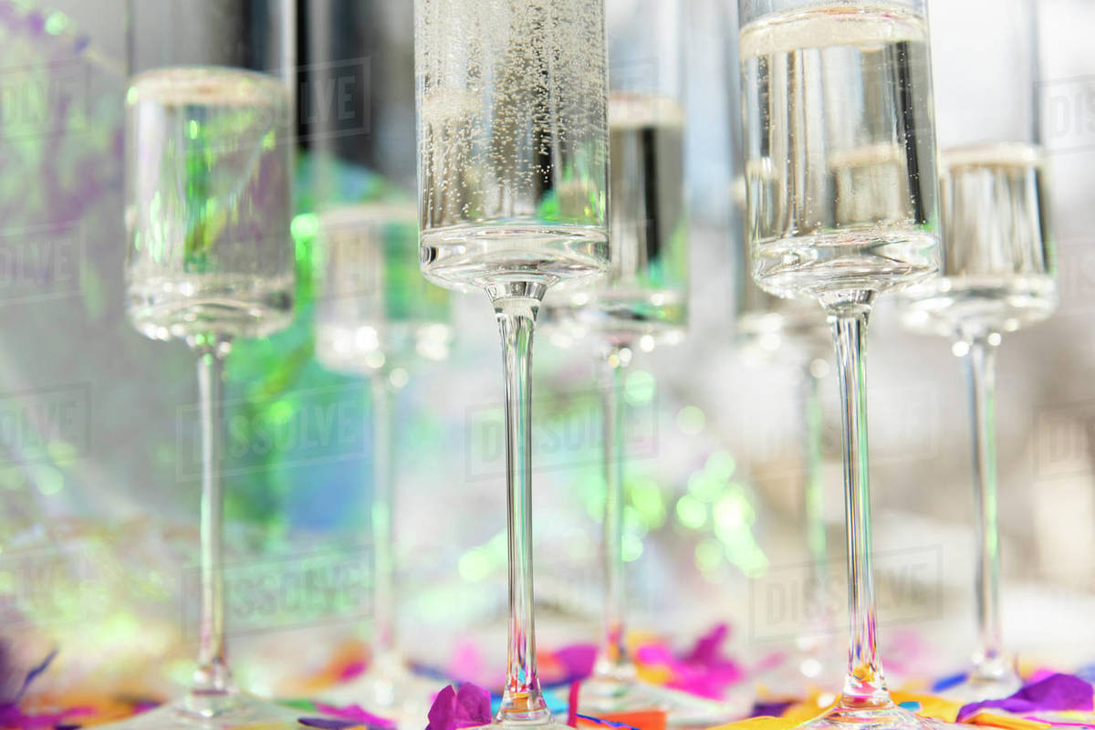 Champagne glasses with confetti Stock Photo Dissolve