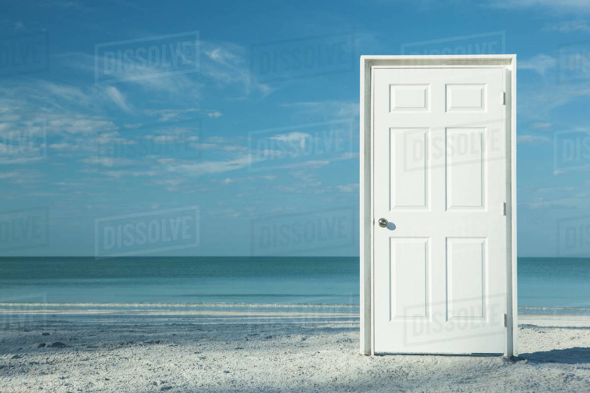 White door on beach Royaltyfree Stock Photo Dissolve