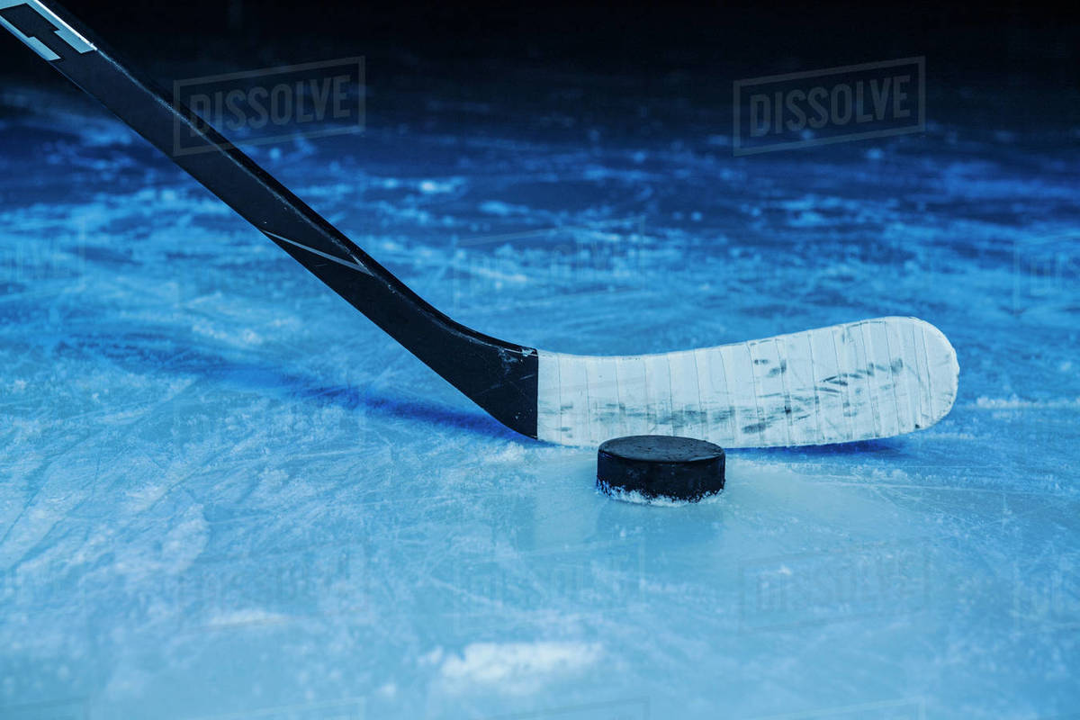 Hockey stick and puck Stock Photo Dissolve