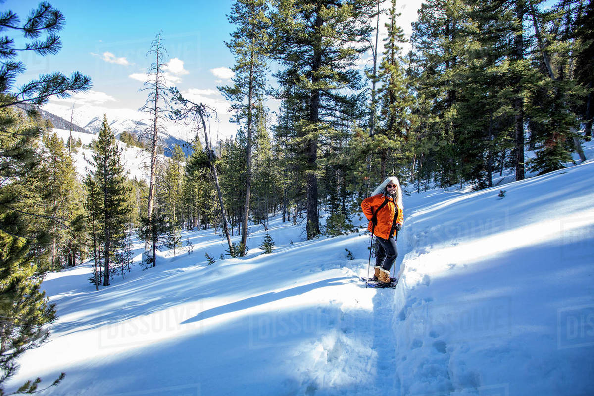 USA, Idaho, Sun Valley, Woman snowshoeing in winter landscape Stock