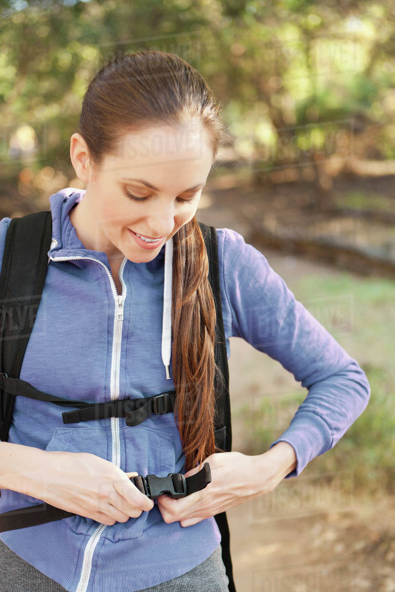 Woman adjusting backpack Stock Photo Dissolve