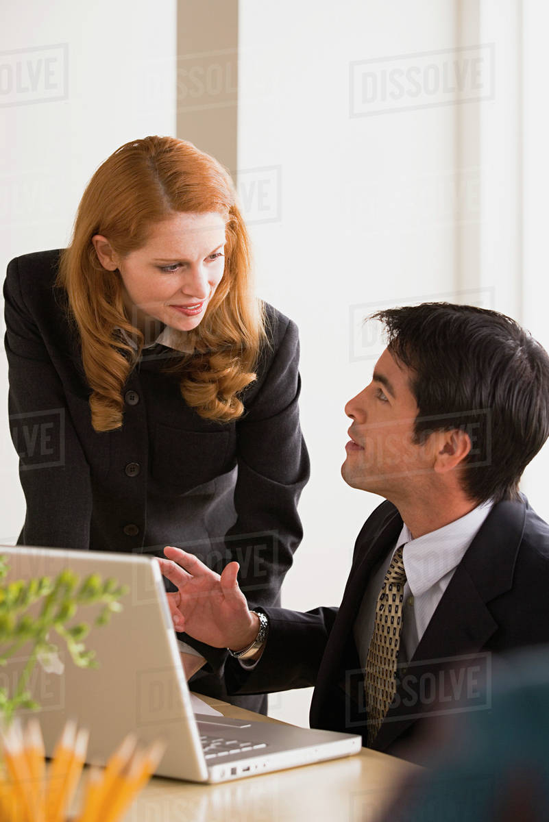 Business man and woman talking - Stock Photo - Dissolve