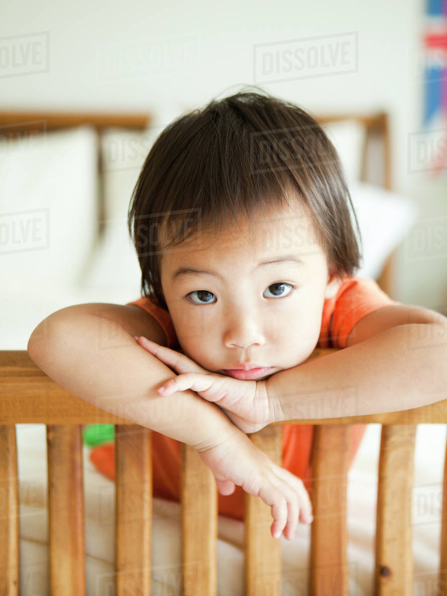 Portrait of girl leaning on bed frame (23) Stock Photo Dissolve