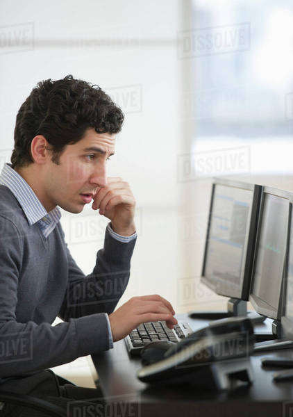 Business man using computer in office - Stock Photo - Dissolve
