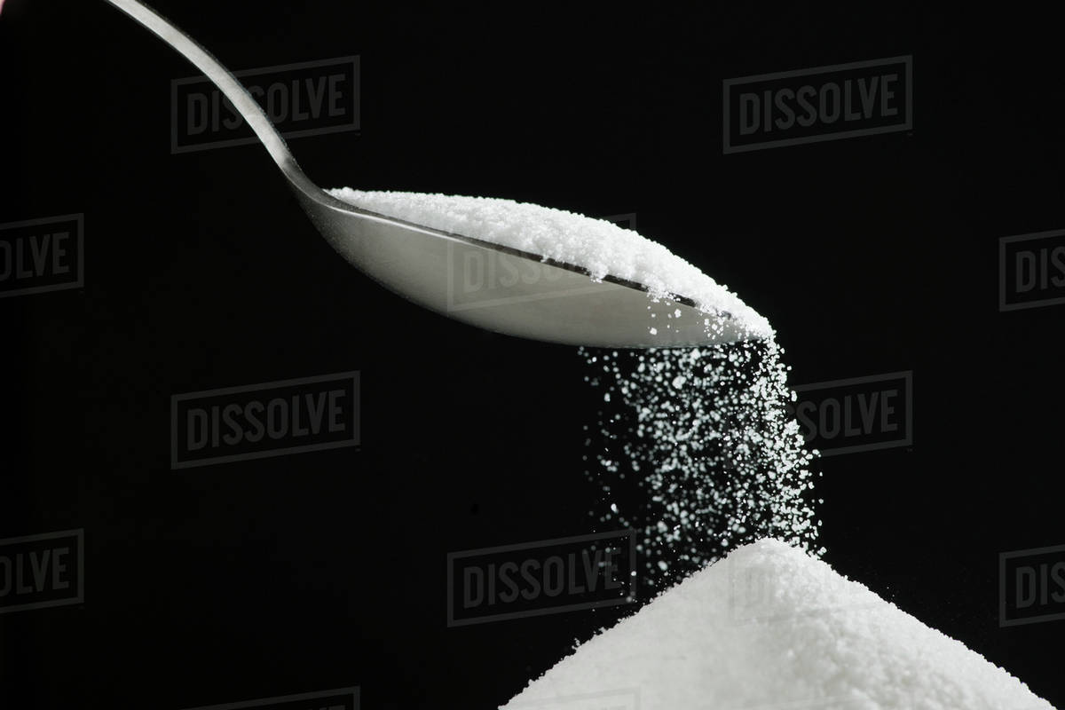 Spoon and heap of sugar Stock Photo Dissolve