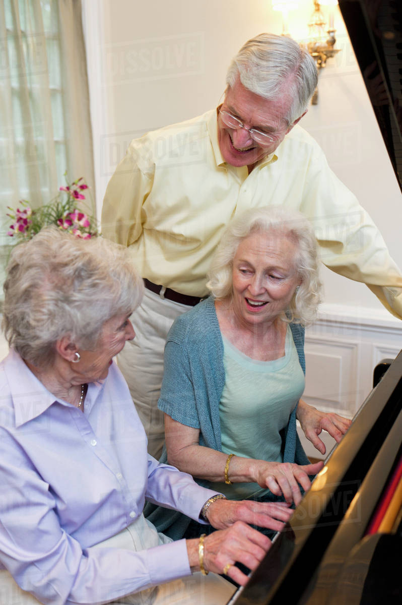 Seniors playing piano and singing - Royalty-free Stock Photo | Dissolve