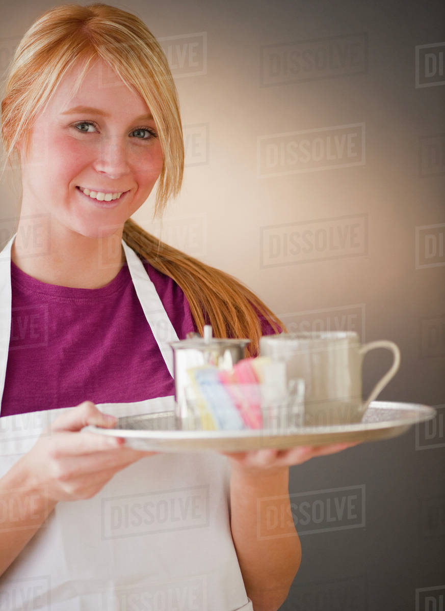 Waitress carrying tray with glass Stock Photo Dissolve