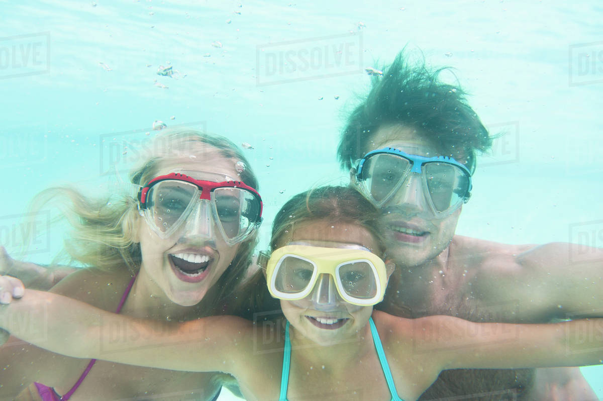 Parents with daughter (1011) swimming underwater Stock Photo Dissolve