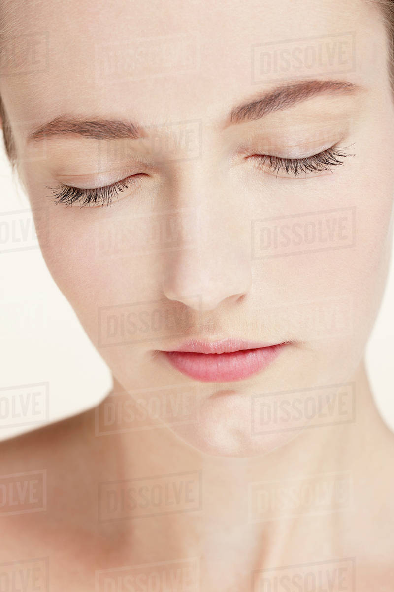 Portrait of young woman with eyes closed Stock Photo Dissolve