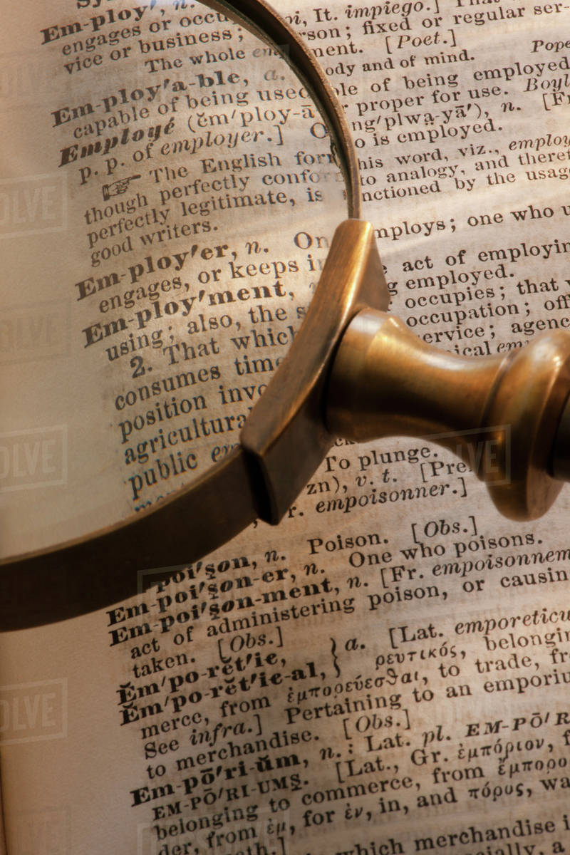 Magnifying glass over dictionary Stock Photo Dissolve