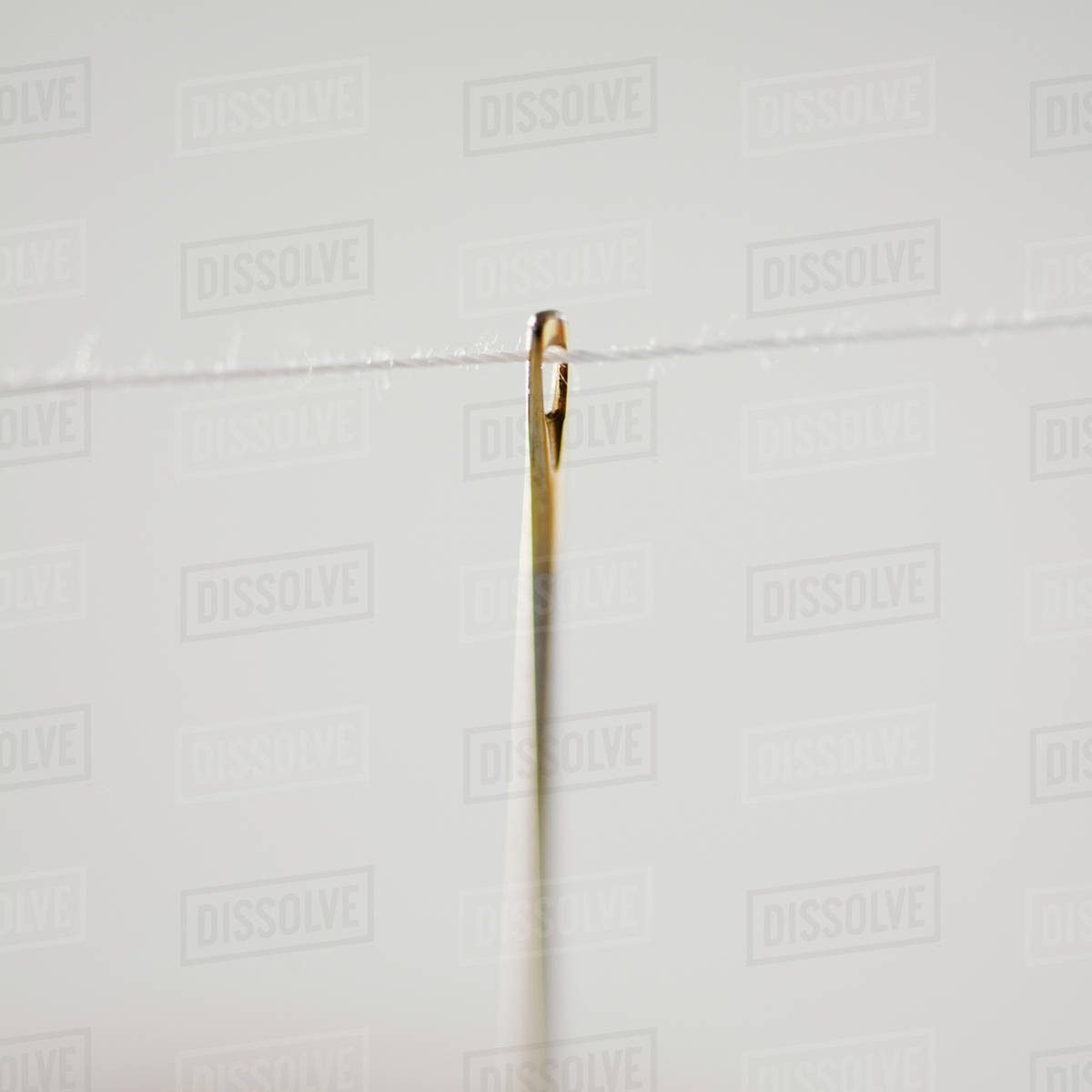 Threaded needle Stock Photo Dissolve