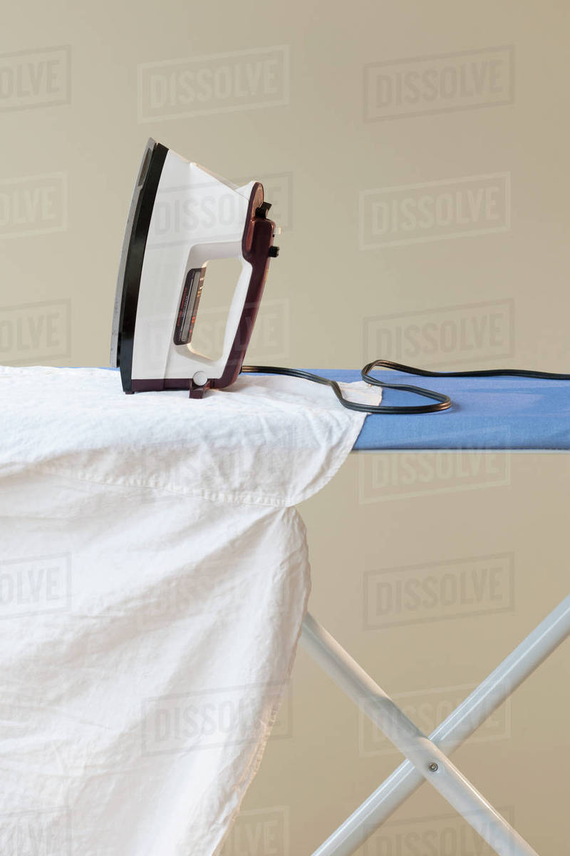 An ironing board with an iron Stock Photo Dissolve