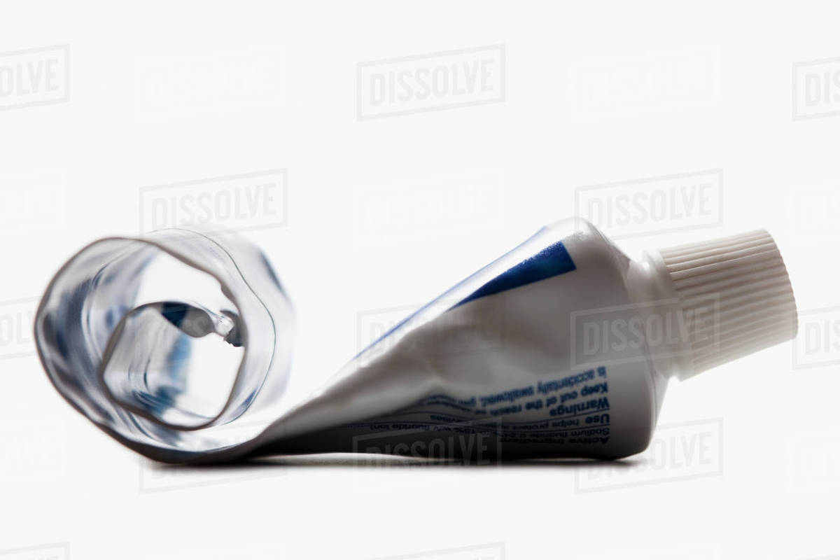 Half empty toothpaste tube Stock Photo Dissolve