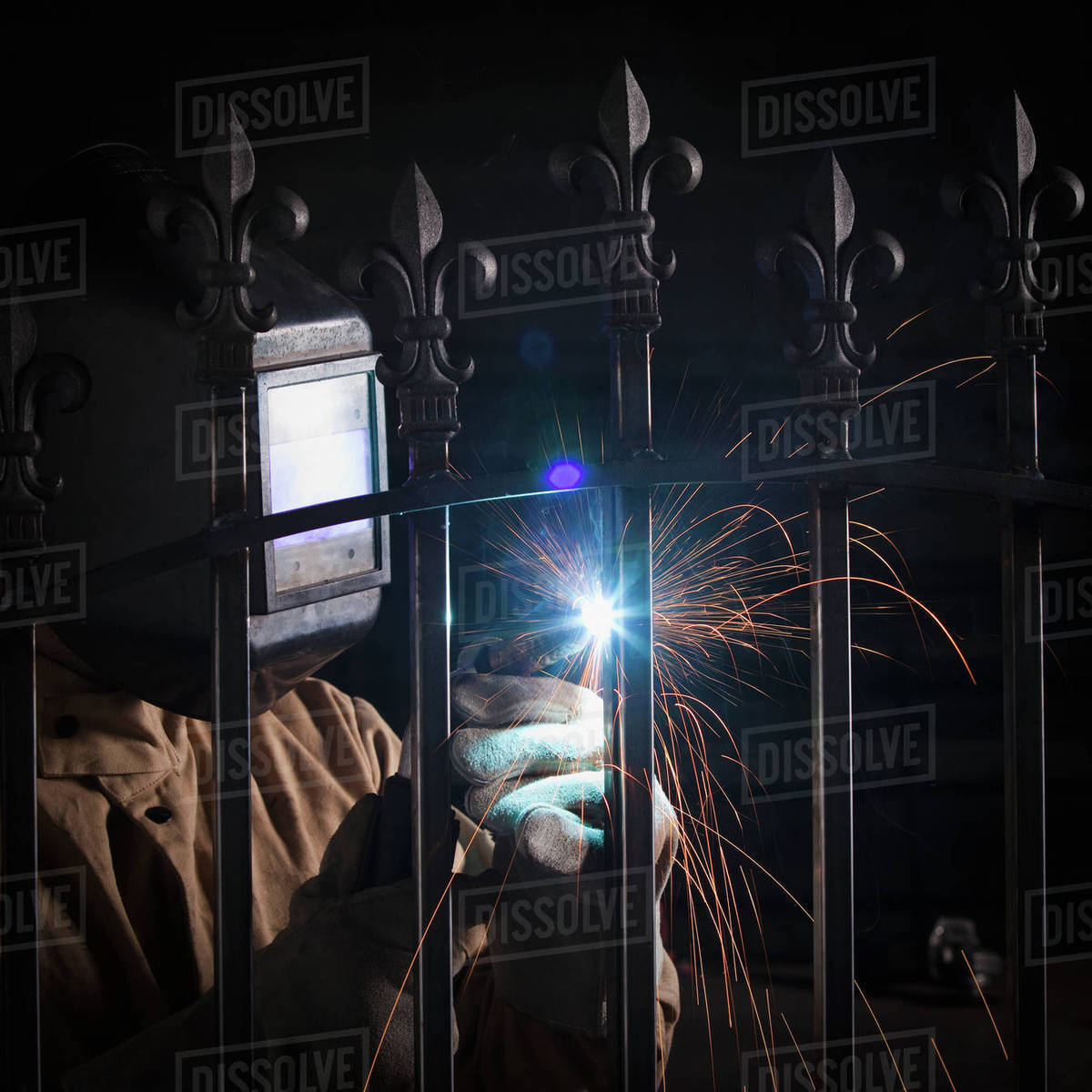 Steel worker welding a fence Stock Photo Dissolve
