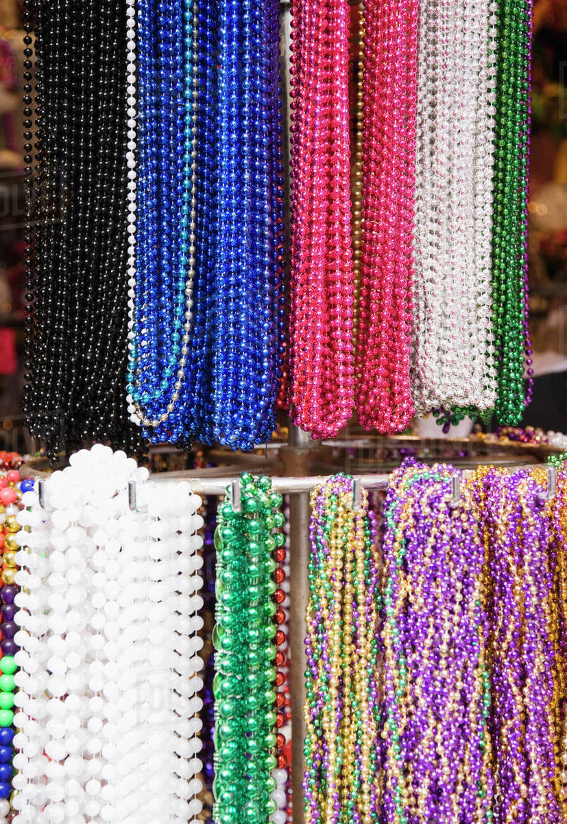 Bead necklaces hanging on rack, French Quarter, New Orleans, Louisiana