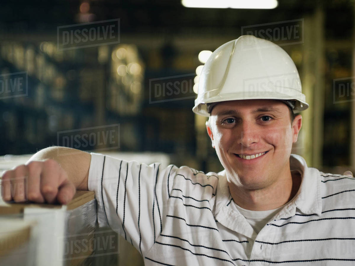 Warehouse worker wearing hard hat Stock Photo Dissolve