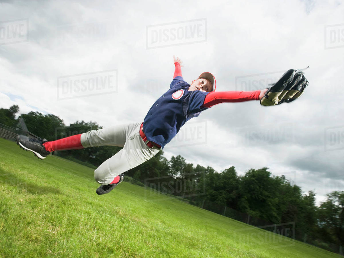 Baseball player diving to catch ball Stock Photo Dissolve