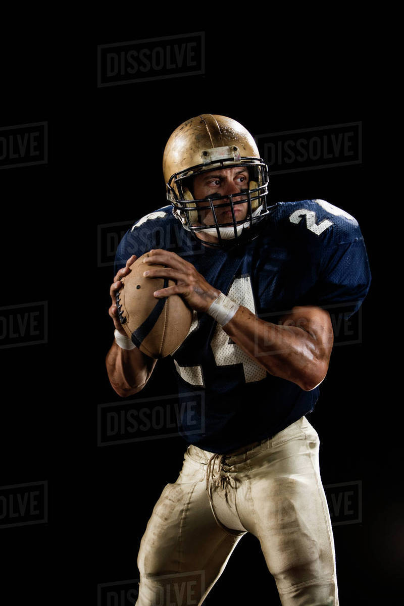 Quarterback preparing to throw football Stock Photo Dissolve