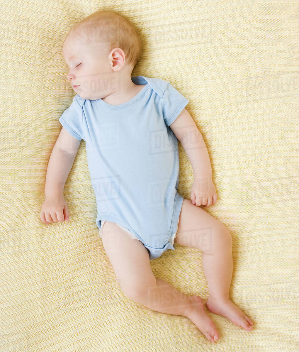 Baby sleeping on bed Stock Photo Dissolve