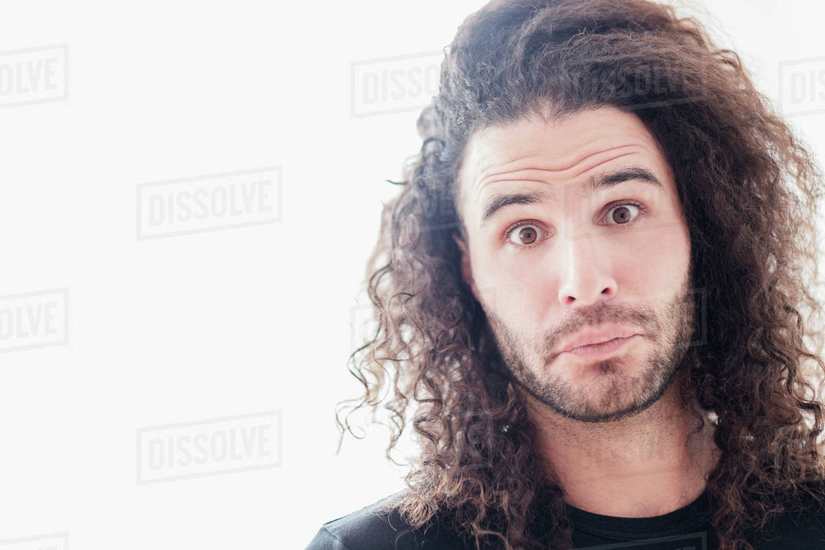 Portrait Of Young Man With Long Curly Hair Stock Photo Dissolve