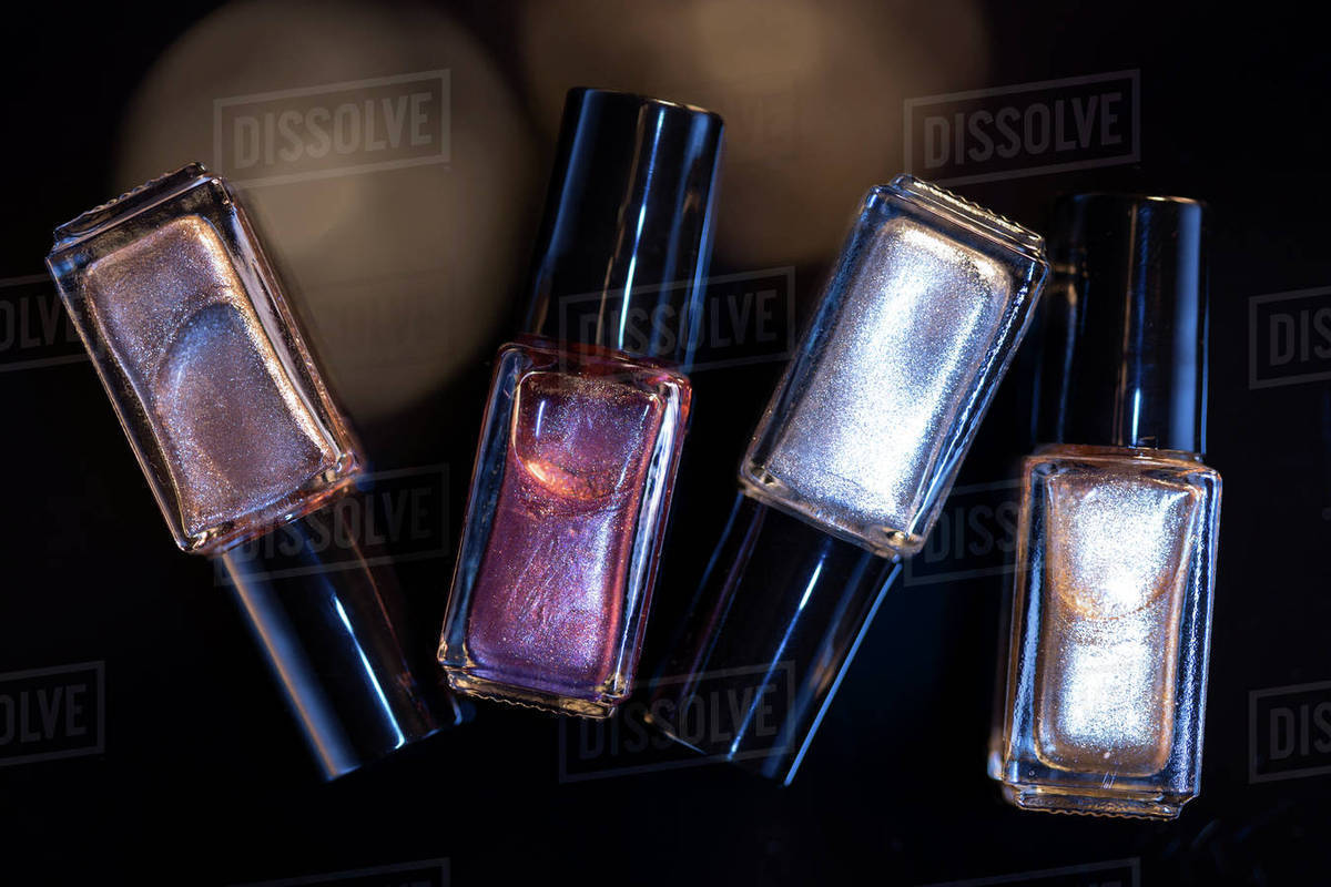 Bottles of nail polish against black background Stock Photo Dissolve
