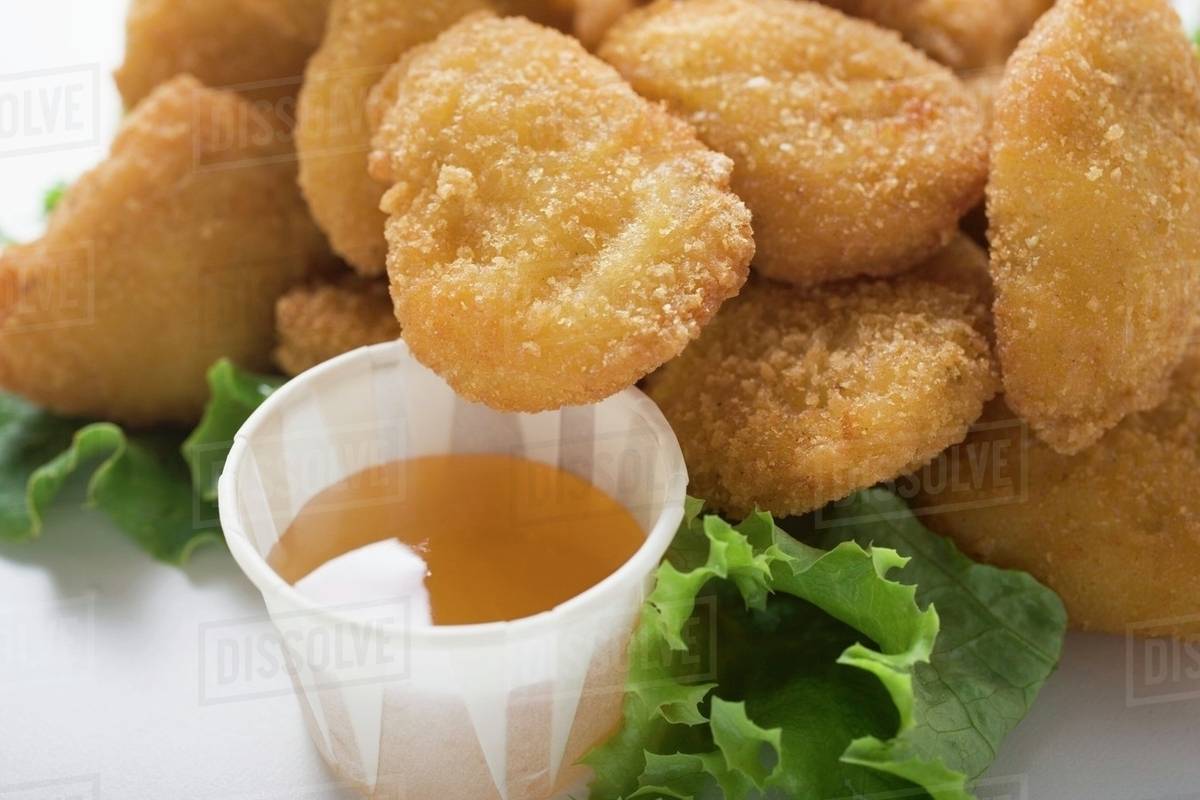 Chicken Nuggets with sweet and sour sauce Stock Photo Dissolve