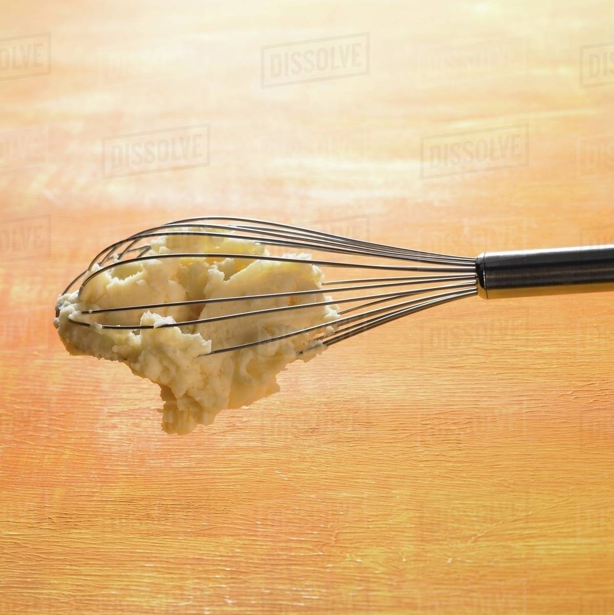 Mashed potato hanging on whisk Stock Photo Dissolve