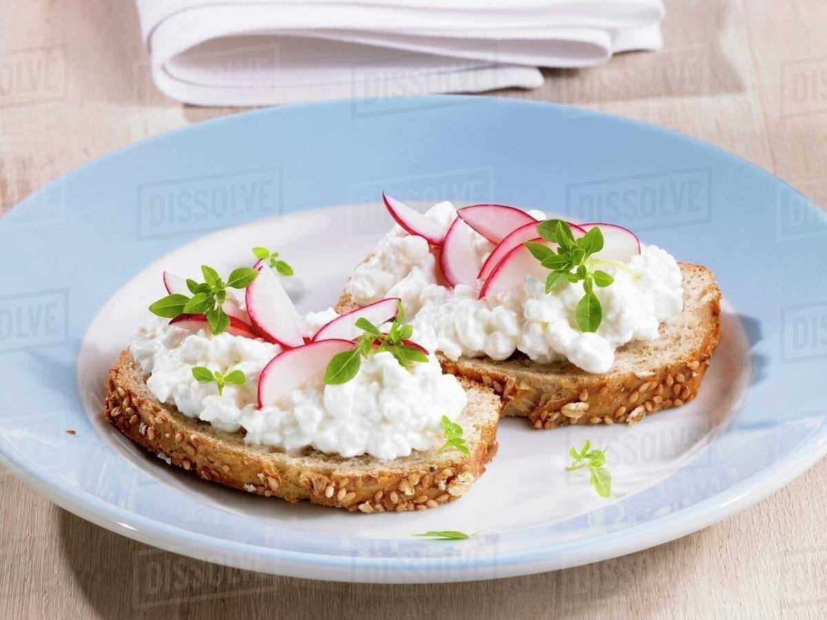 Cottage cheese and radishes on bread Stock Photo Dissolve