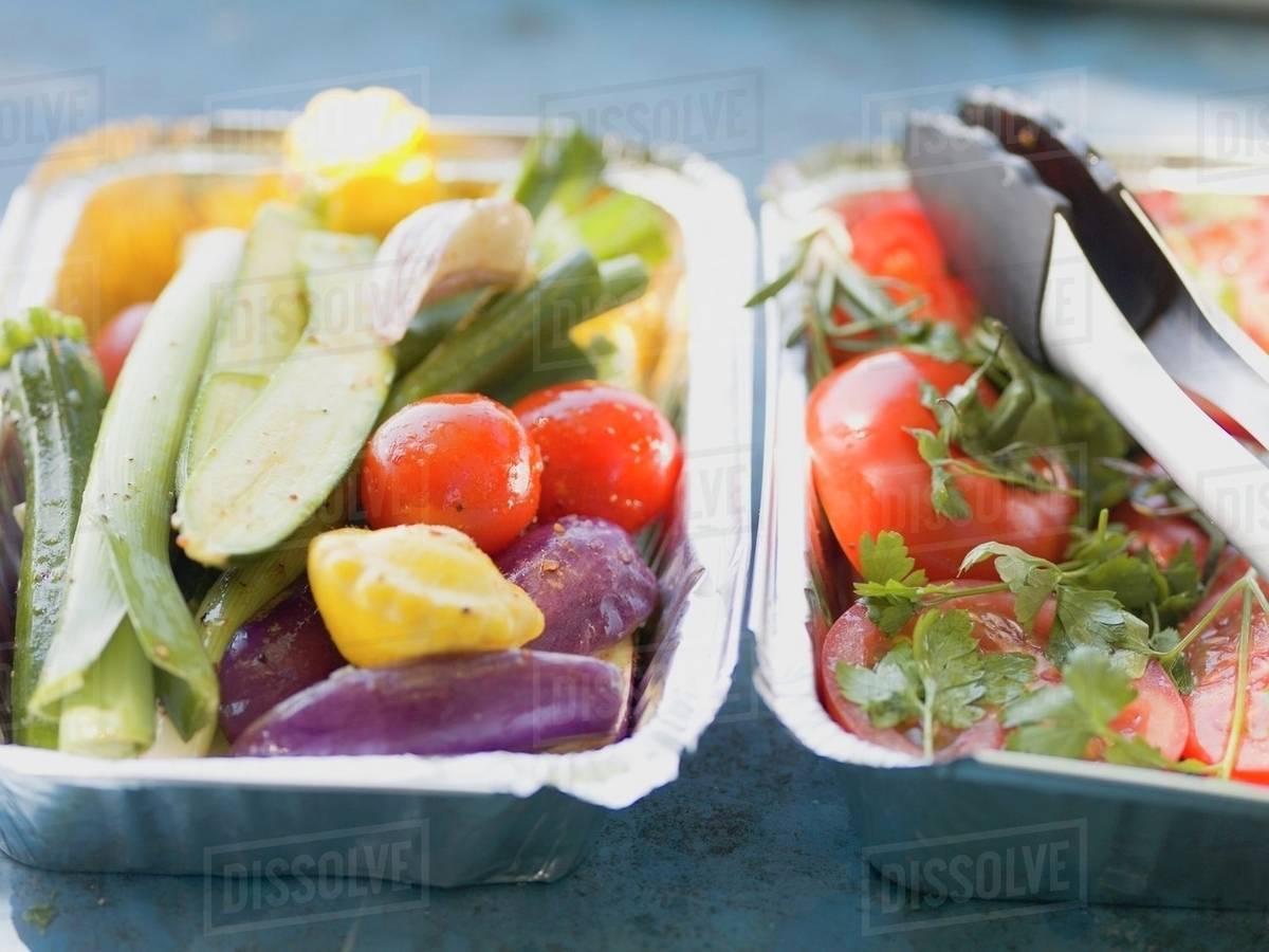 Vegetables in aluminium dishes, ready for grilling Stock Photo Dissolve