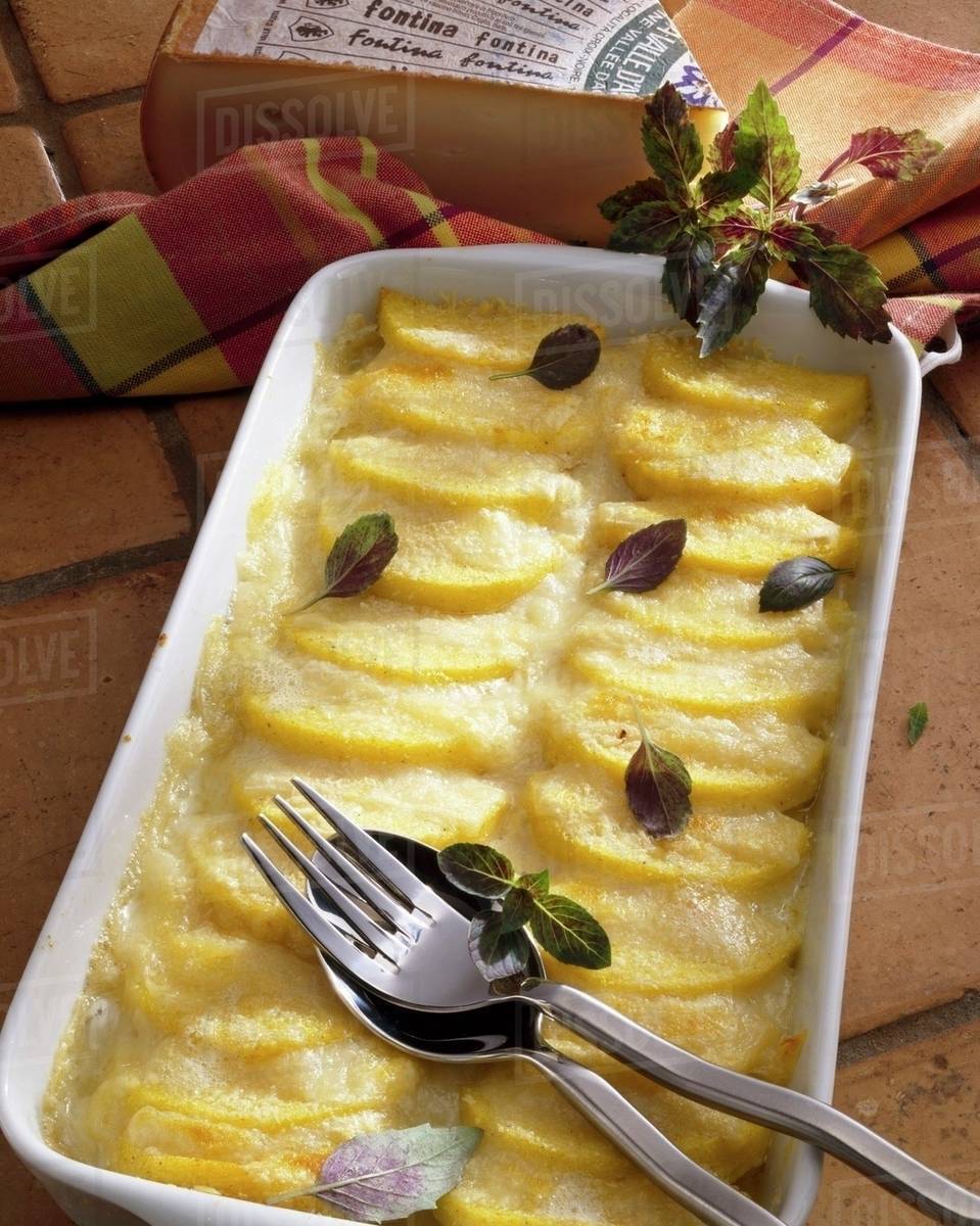 Baked polenta with Fontina cheese Stock Photo Dissolve