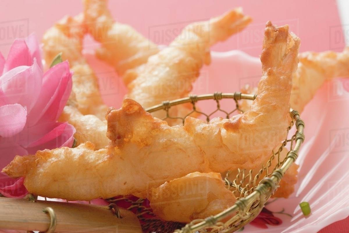Deepfried prawns in batter in straining spoon (Asia) Stock Photo