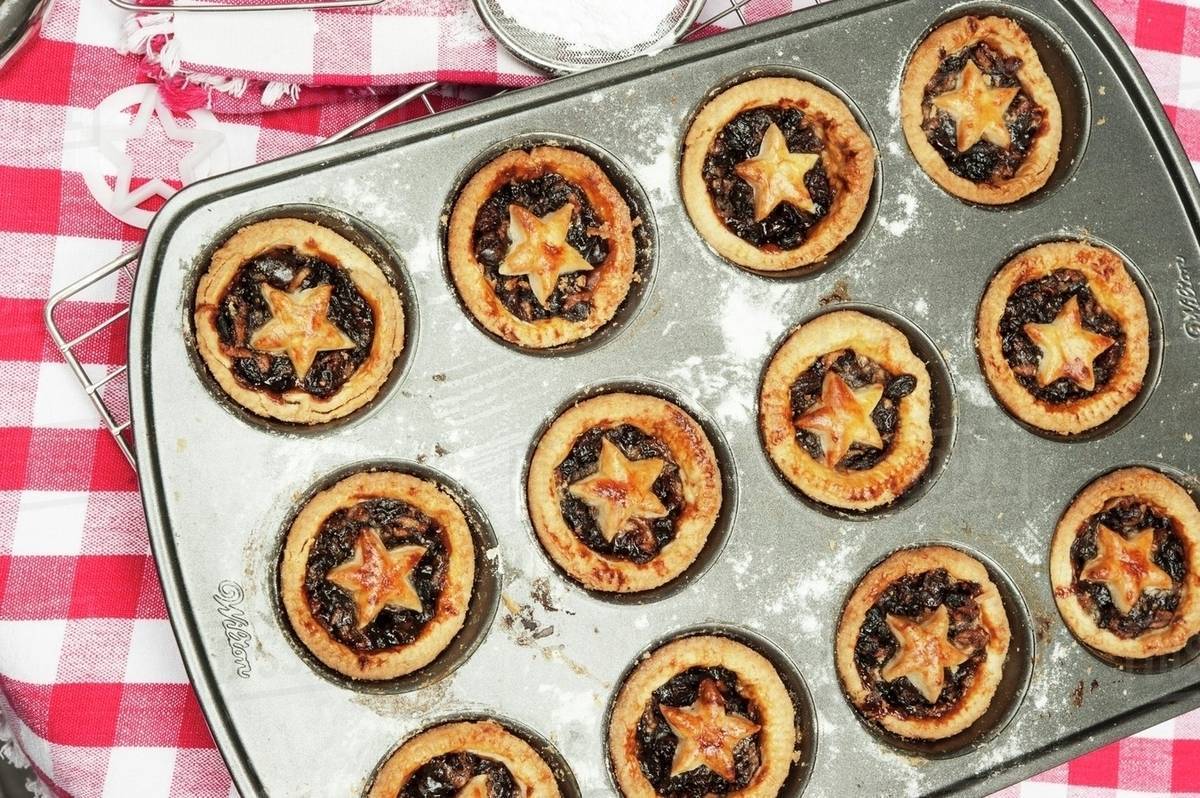 Mince pies in the baking tin Stock Photo Dissolve