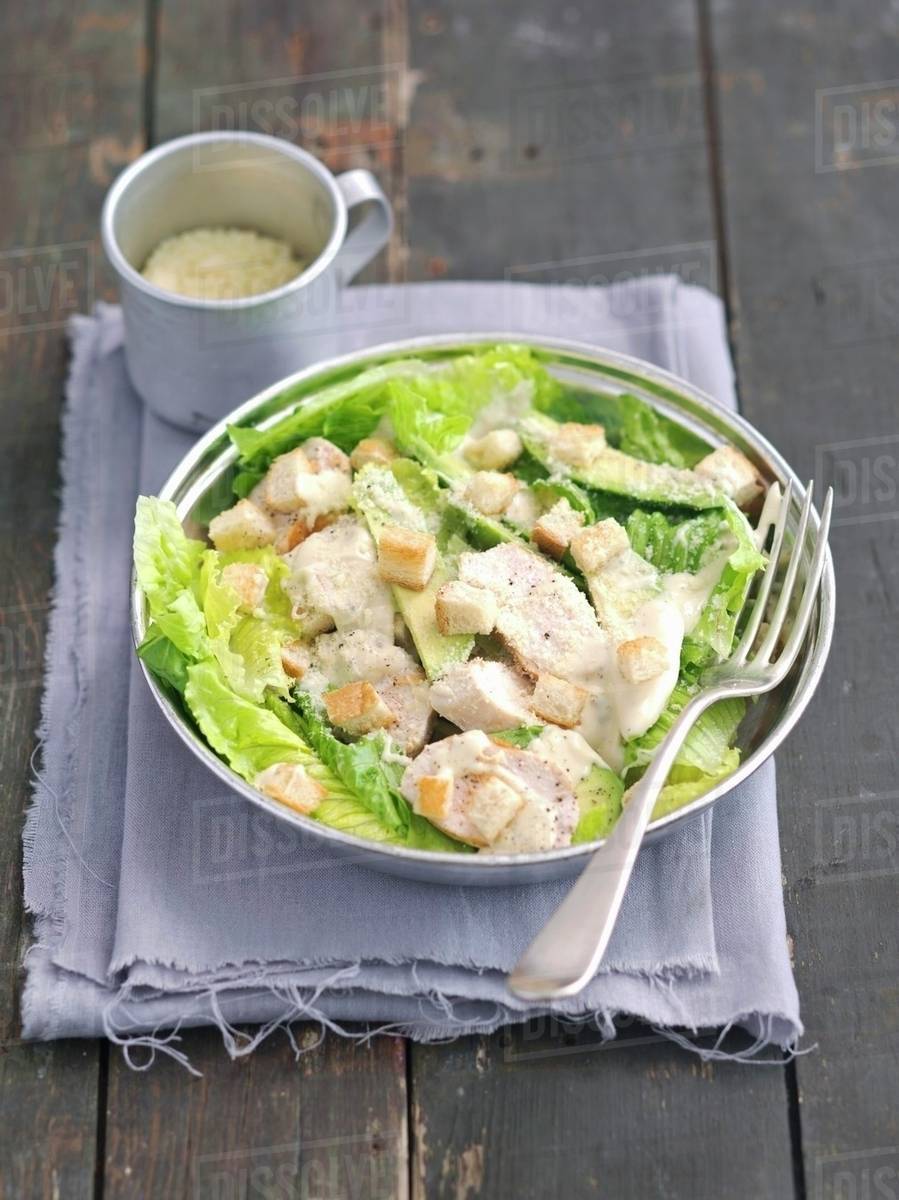 Caesar salad with avocado, grilled chicken and croutons Stock Photo