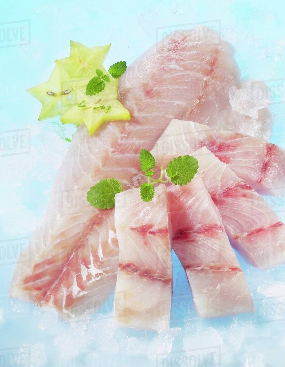 Fresh Victoria Perch Fillets With Lemon Balm And Star Fruit Stock Photo Dissolve