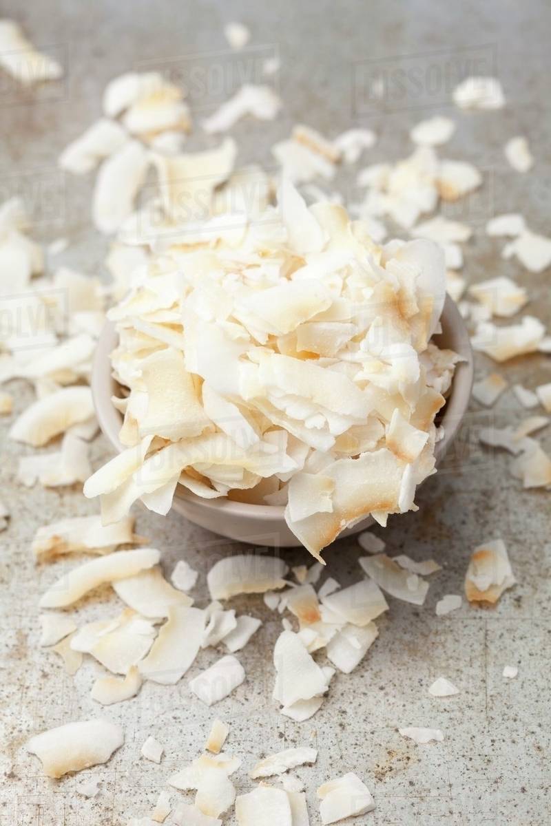 Coconut flakes in a grey bowl Stock Photo Dissolve