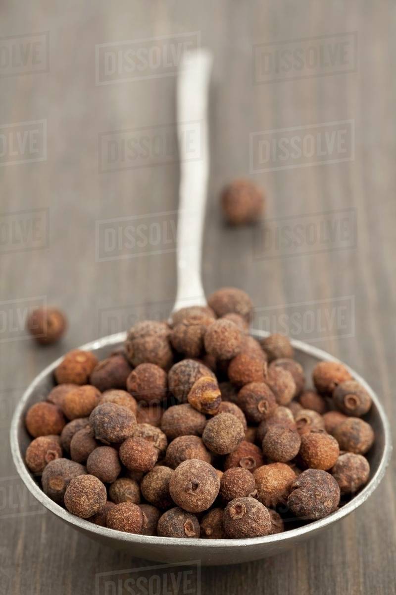 A spoon full of allspice berries Stock Photo Dissolve
